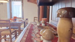 a room with a table with a lamp and a dining room at Casa Savilla by Ca-Sa Check in Pieve di Cadore
