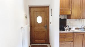 a kitchen with a wooden door and a sink at Casa Savilla by Ca-Sa Check in Pieve di Cadore