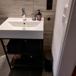 a bathroom sink with two glasses on top of it at Gemütlich wohnen nahe Frankfurt in Karben