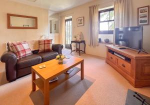 a living room with a couch and a television at Rubbing House in Marske