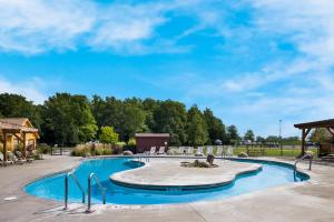 a swimming pool at a resort with a blue sky at HTR Niagara in Grand Island