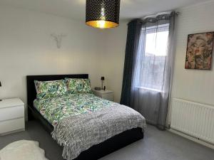 a bedroom with a bed and a window at 2 Millway in Golden Valley
