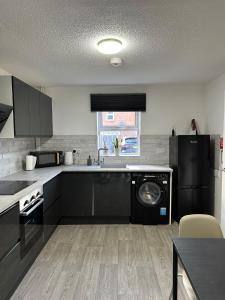 a kitchen with a sink and a dishwasher at 2 Millway in Golden Valley