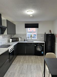 a kitchen with a washer and a dishwasher at 2 Millway in Golden Valley +5 photos