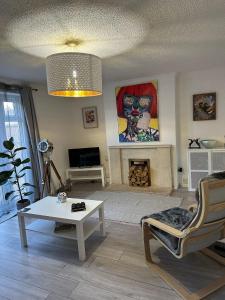 a living room with a coffee table and a fireplace at 2 Millway in Golden Valley