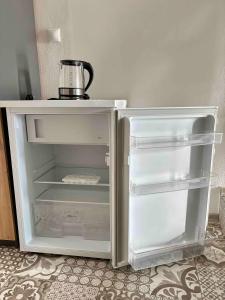 an empty refrigerator with its door open in a kitchen at Apartmán U Štýbnarů in Bulhary