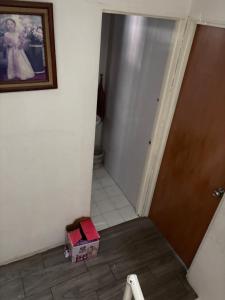 a hallway with a door and two boxes on the floor at Víctorhaus in San Gregorio Cuautzingo