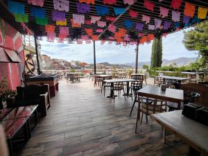 a restaurant with tables and chairs and colorful flags at Hotel 1988 Guanajuato in Guanajuato