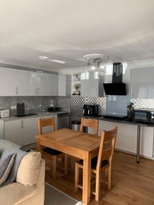 a kitchen and dining room with a wooden table at Crayford's Guest House in Aberdeen