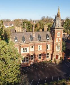 an aerial view of a large brick building with a tower at Brownsover Hall Hotel in Rugby