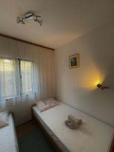 a bedroom with a bed with a towel on it at Apartment Mladinić in Okrug Donji