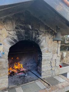 a large brick oven with a fire in it at Apartment Mladinić in Okrug Donji