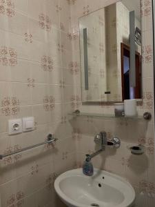 a bathroom with a sink and a mirror at Apartment Mladinić in Okrug Donji +9 photos