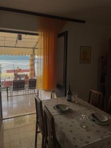 a dining room table with a view of the ocean at Apartment Mladinić in Okrug Donji