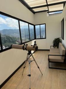 a camera on a tripod in a room with windows at Boreal House in Manizales