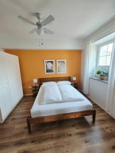 a bedroom with a bed and a ceiling fan at 2-Zimmer Wohnung 2 - Apartments am Schloss in Oberschleißheim