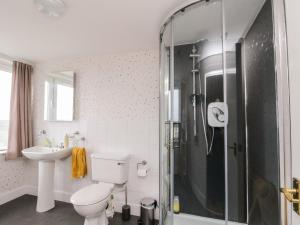 a bathroom with a toilet and a sink and a shower at Seaview Wellness Retreat in Carnoustie +53 photos