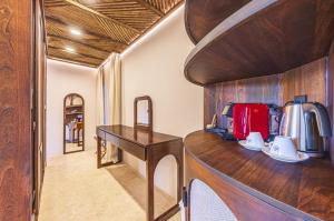 a room with a wooden desk with a tea kettle at Tiki Villas Rainforest Lodge - Adults Only in Uvita