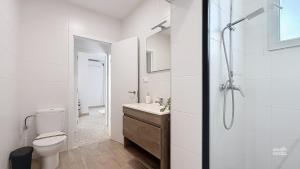 a white bathroom with a toilet and a shower at Villa Almirante Torrecilla by South Costa in Nerja