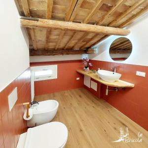 a bathroom with a white toilet and a sink at La Bricola - Buora in Chioggia