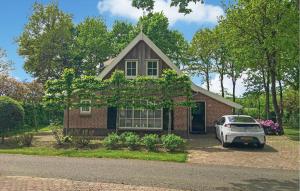 a house with a car parked in front of it at Buitengoed Het Lageveld - 56 in Hoge-Hexel