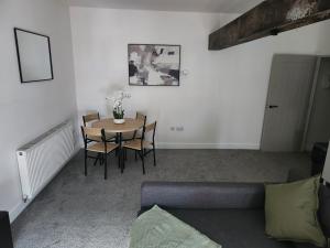 a living room with a table and chairs and a couch at C&B Holdings in Hull +11 photos