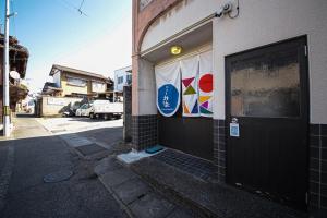 a building with a door with a banner on it at ニューお染 in Kotohira