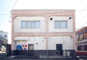 a white building with windows on the side of it at ニューお染 in Kotohira