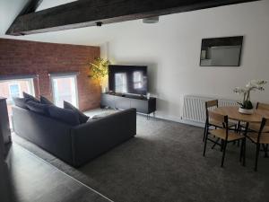 a living room with a couch and a table at C&B Holdings in Hull