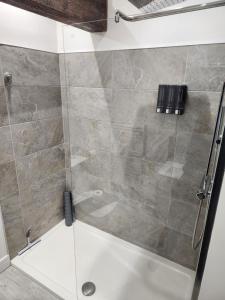 a shower in a bathroom with a glass door at C&B Holdings in Hull