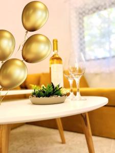 a table with a bottle of wine and two glasses at Guest House Julia in Stavros