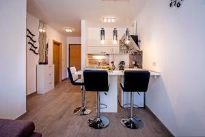 a kitchen with a counter and two bar stools at Secret Escape in Rovinj +17 photos
