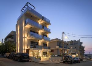 a building with cars parked in front of it at Allegro Suites in Rethymno