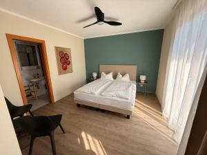 a bedroom with a bed and a ceiling fan at AL BOCCALINO Bed & Breakfast Melide Lugano Ticino in Melide