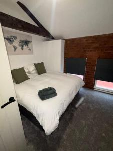 a bedroom with a white bed in a room at C&B Holdings in Hull