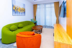 a living room with a green couch and a table at T-Stone Apartments Hotels -Kigali in Kigali