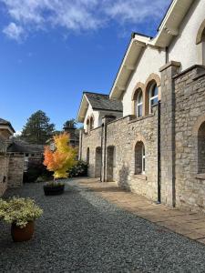 a large stone building with a pathway in front of it at Underscar - Luxury 1 Bed Apartment in Applethwaite