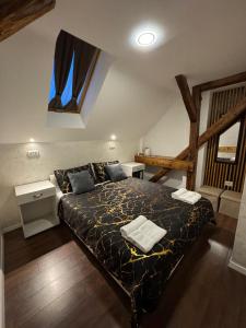 a bedroom with a large bed in a attic at TOMISLAV in Zagreb