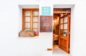 a door to a building with a sign on it at Calma Hotel in Ciutadella