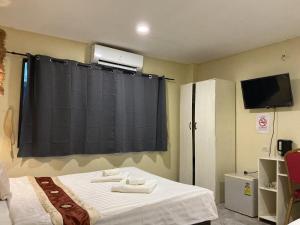a room with a bed with a black curtain at Istanbul Boutique Hotel in Patong Beach
