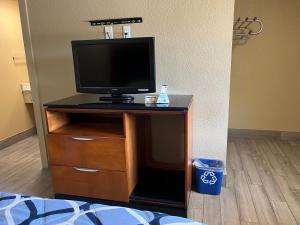 a tv on a dresser in a room at Bragg Motel in Upper Marlboro
