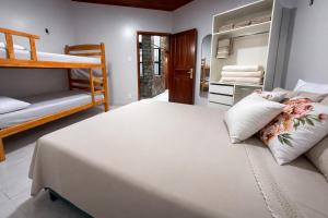 a bedroom with a bed and a bunk bed at Casarão Figueiredo in Presidente Figueiredo +26 photos