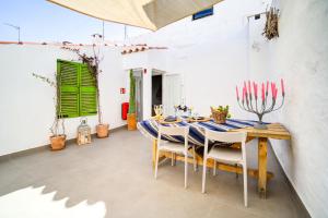 a dining room with a blue and white table and chairs at Calma Hotel in Ciutadella +27 photos