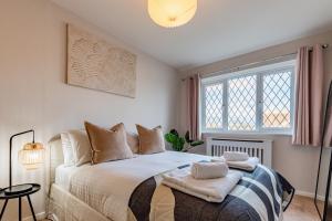 a bedroom with a large white bed with a window at Drovers Way, Worcester in Fernhill Heath