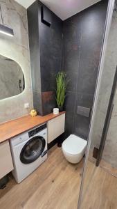a bathroom with a washing machine and a toilet at Wyspa9 - Gdańsk Wyspa Sobieszewska in Gdańsk +15 photos