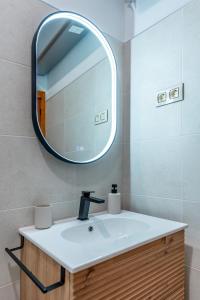 a bathroom with a sink and a mirror at El Cerrillo in Navaconcejo +40 photos