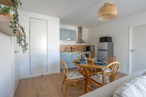 a kitchen and dining room with a table and chairs at L'Escale d'Erdeven - En centre-bourg in Erdeven