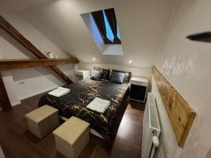 a bedroom with a bed with two stools in it at TOMISLAV in Zagreb