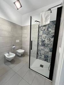 a bathroom with a glass shower and a toilet at La Maison de Marcelle in Tropea +19 photos