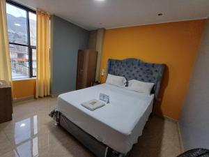 a bedroom with a large bed in a room at Hotel Emmanuel in Chepén +13 photos